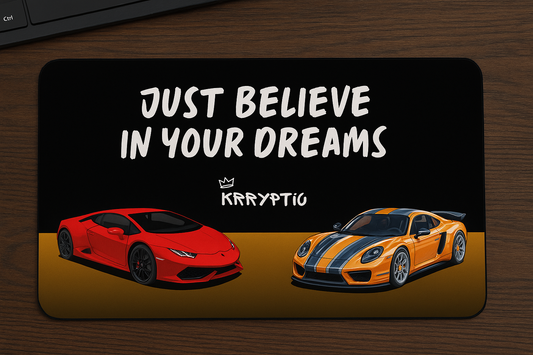Motivational card with two sports cars and 'Just Believe in Your Dreams' text on a wooden surface.